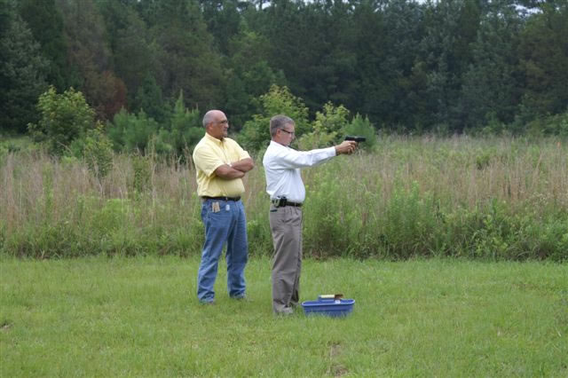 Representative R. Keith Kelly qualifying at the range under the
watchful eye of Representative Mike Pitts, Instructor.