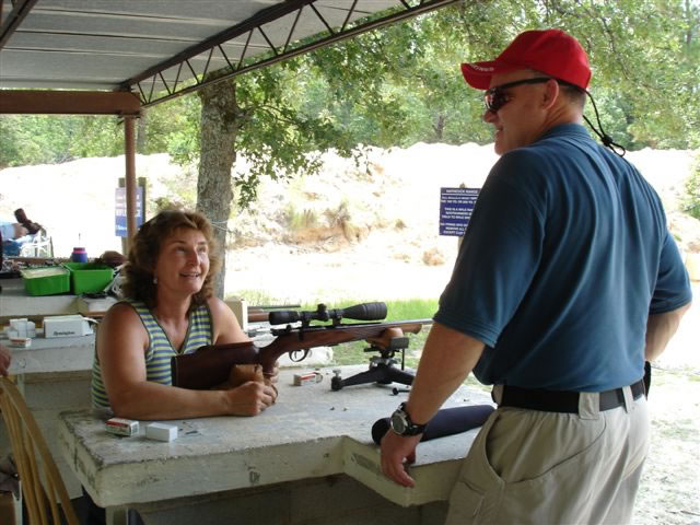 Sue Lifsey of Chapin takes aim with a .22 semi-automatic pistol as instructor Michael Andrews looks on.